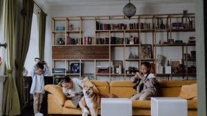 Family relaxing together with their dog in a cozy living room setting, capturing a warm and playful moment.