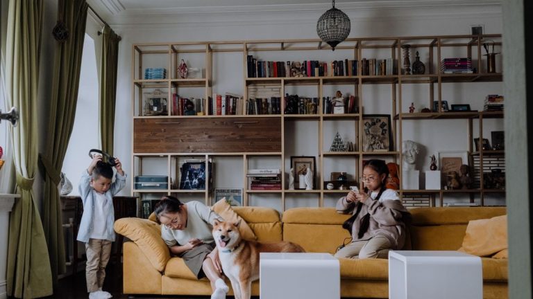 Family relaxing together with their dog in a cozy living room setting, capturing a warm and playful moment.